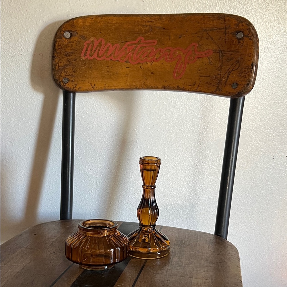 Pair of amber colored glass candle holders one taper one votive